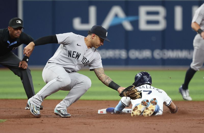 Jul 9, 2024; St. Petersburg, Florida, USA; New York Yankees second base Gleyber Torres (25) tags out Tampa Bay Rays shortstop Jose Caballero (7) as he attempted to steal during the first inning at Tropicana Field. Mandatory Credit: Kim Klement Neitzel-USA TODAY Sports