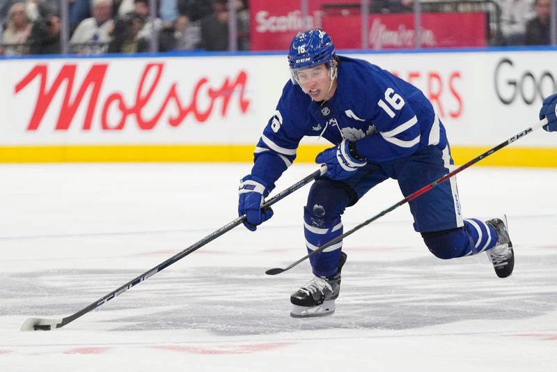 Oct 21, 2024; Toronto, Ontario, CAN; Toronto Maple Leafs forward Mitch Marner (16) controls the puck against the Tampa Bay Lightning during the third period at Scotiabank Arena. Mandatory Credit: John E. Sokolowski-Imagn Images