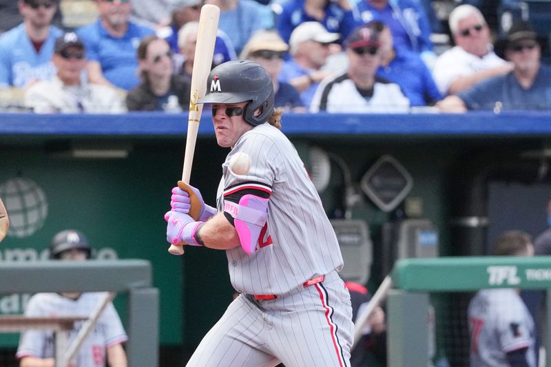 Apr 10, 2025; Kansas City, Missouri, USA; Minnesota Twins center fielder Harrison Bader (12) reacts against the Kansas City Royals after being hit by a pitch in the 9th inning at Kauffman Stadium. Mandatory Credit: Denny Medley-Imagn Images