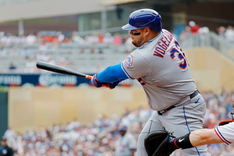 Sep 9, 2023; Minneapolis, Minnesota, USA; New York Mets designated hitter Daniel Vogelbach (32) hits an RBI single against the Minnesota Twins in the first inning at Target Field. Mandatory Credit: Bruce Kluckhohn-USA TODAY Sports