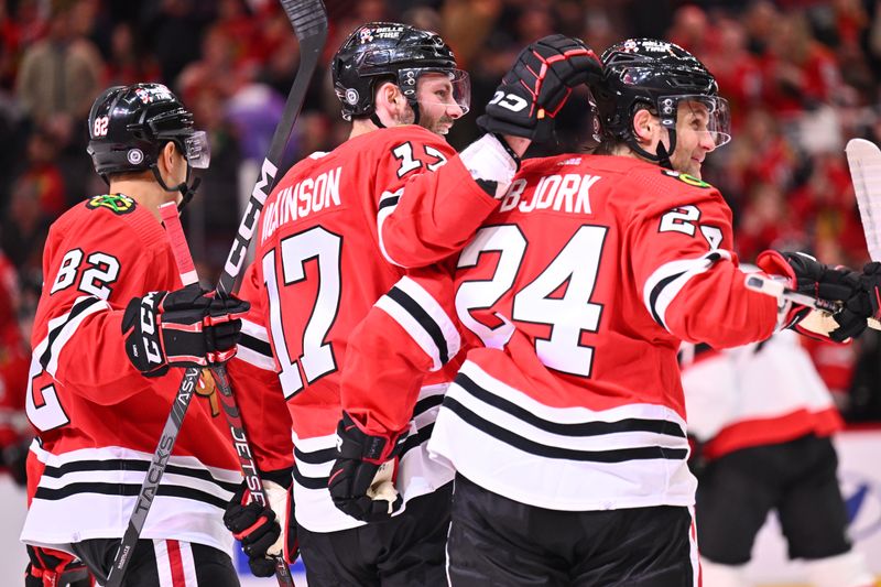 Mar 6, 2023; Chicago, Illinois, USA;  Chicago Blackhawks forward Jason Dickinson (17) celebrates with defenseman Caleb Jones (82) and forward Anders Bjork (24) after scoring a goal in the second period against the Ottawa Senators at United Center. Mandatory Credit: Jamie Sabau-USA TODAY Sports