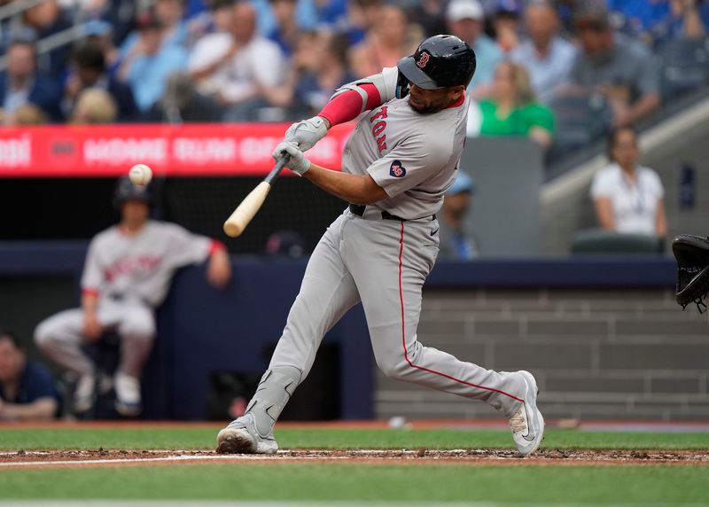 Jun 18, 2024; Toronto, Ontario, CAN; Boston Red Sox first baseman Dominic Smith (2) hits a one run single against the Toronto Blue Jays during the second inning at Rogers Centre. Mandatory Credit: John E. Sokolowski-USA TODAY Sports