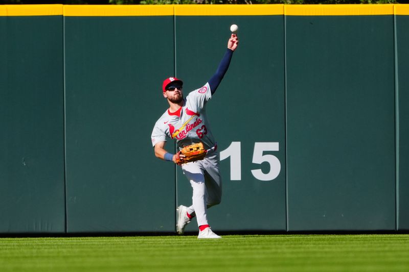 Sep 26, 2024; Denver, Colorado, USA; St. Louis Cardinals center fielder Michael Siani (63) fields the ball in the eighth inning against the Colorado Rockies at Coors Field. Mandatory Credit: Ron Chenoy-Imagn Images