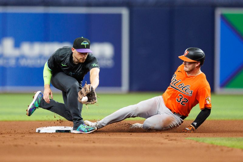 Jun 8, 2024; St. Petersburg, Florida, USA;  Baltimore Orioles outfielder Ryan O'Hearn (32) steals second base from Tampa Bay Rays second baseman Brandon Lowe (8) in the eighth inning at Tropicana Field. Mandatory Credit: Nathan Ray Seebeck-USA TODAY Sports