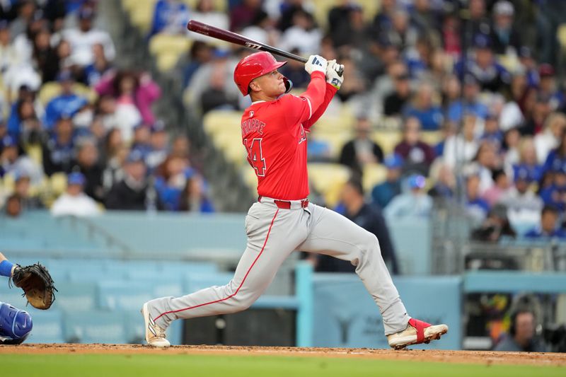 Mar 25, 2024; Los Angeles, California, USA; Los Angeles Angels catcher Logan O'Hoppe (14) follows through on a three-run home run in the second inning against the Los Angeles Dodgers at Dodger Stadium. Mandatory Credit: Kirby Lee-USA TODAY Sports