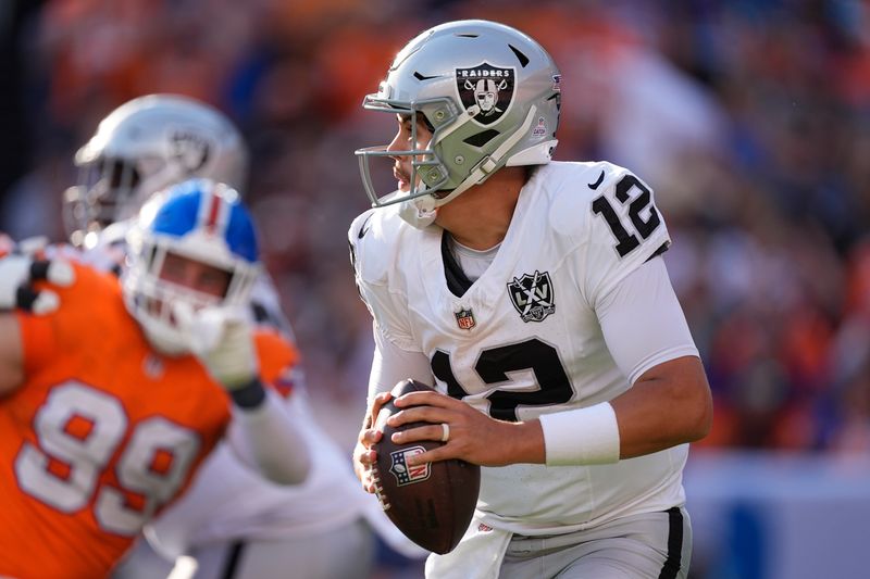 Las Vegas Raiders quarterback Aidan O'Connell looks downfield during the second half of an NFL football game against the Denver Broncos, Sunday, Oct. 6, 2024, in Denver. (AP Photo/David Zalubowski)