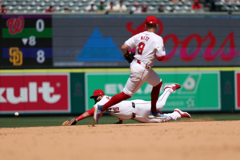 Jun 26, 2024; Anaheim, California, USA;  Los Angeles Angels second baseman Luis Guillorme (15) dives for the ball on a base hit by Oakland Athletics designated hitter Brent Rooker (25, not pictured) during the eighth inning at Angel Stadium. Mandatory Credit: Kiyoshi Mio-USA TODAY Sports
