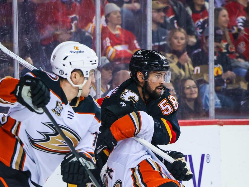 Apr 2, 2024; Calgary, Alberta, CAN; Calgary Flames defenseman Oliver Kylington (58) and Anaheim Ducks right wing Jakob Silfverberg (33) battles for the puck during the first period at Scotiabank Saddledome. Mandatory Credit: Sergei Belski-USA TODAY Sports