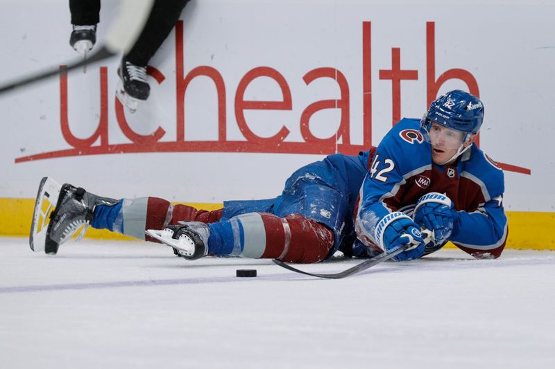 Jan 8, 2026; Denver, Colorado, USA; Colorado Avalanche defenseman Josh Manson (42) plays the puck from the ice in the third period against the Ottawa Senators at Ball Arena. Mandatory Credit: Isaiah J. Downing-Imagn Images
