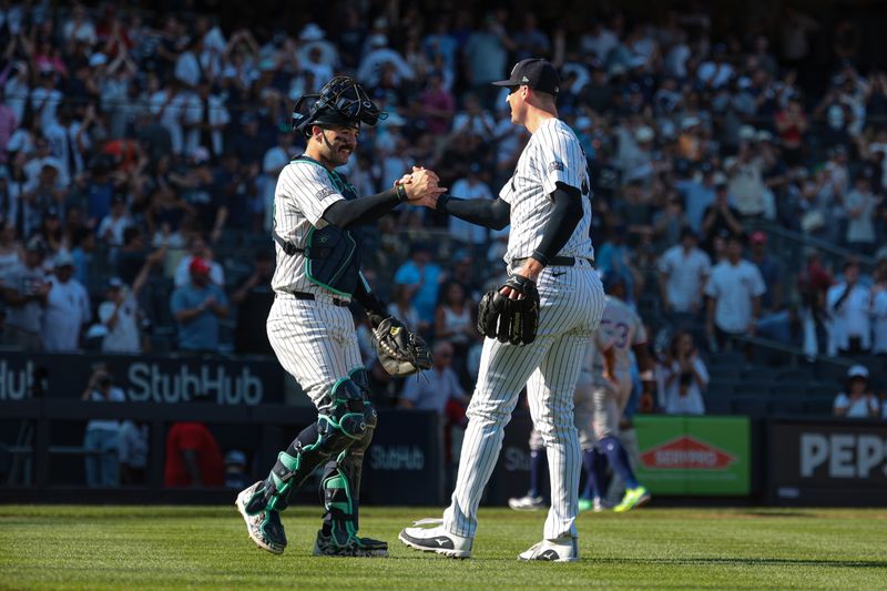 Aug 11, 2024; Bronx, New York, USA; New York Yankees relief pitcher Clay Holmes (35) celebrates with catcher Austin Wells (28) after the game against the Texas Rangers at Yankee Stadium. Mandatory Credit: Vincent Carchietta-USA TODAY Sports