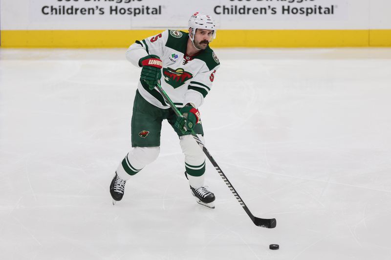 Jan 19, 2024; Sunrise, Florida, USA; Minnesota Wild defenseman Jake Middleton (5) moves the puck against the Florida Panthers during the third period at Amerant Bank Arena. Mandatory Credit: Sam Navarro-USA TODAY Sports