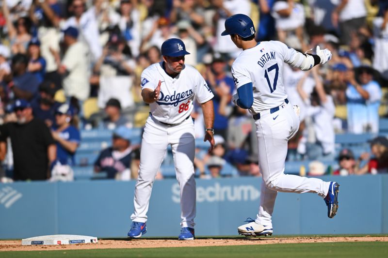 Jul 21, 2024; Los Angeles, California, USA; Los Angeles Dodgers designated hitter Shohei Ohtani (17) celebrates with first base coach Clayton McCullough (86) after hitting a home run against the Boston Red Sox during the fifth inning at Dodger Stadium. Mandatory Credit: Jonathan Hui-USA TODAY Sports