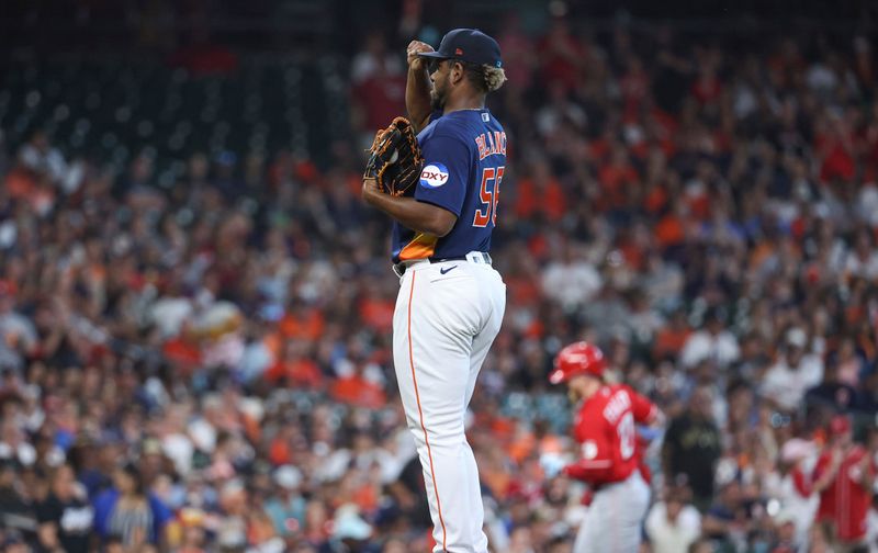 Jun 18, 2023; Houston, Texas, USA; Houston Astros starting pitcher Ronel Blanco (56) reacts and Cincinnati Reds left fielder Jake Fraley (27) rounds the bases after hitting a home run during the second inning at Minute Maid Park. Mandatory Credit: Troy Taormina-USA TODAY Sports