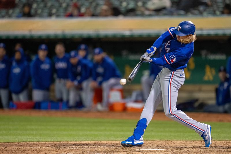 May 6, 2024; Oakland, California, USA; Texas Rangers outfielder Travis Jankowski (16) reaches on a fielding error scoring one run against the Oakland Athletics during the ninth inning at Oakland-Alameda County Coliseum. Mandatory Credit: Neville E. Guard-USA TODAY Sports