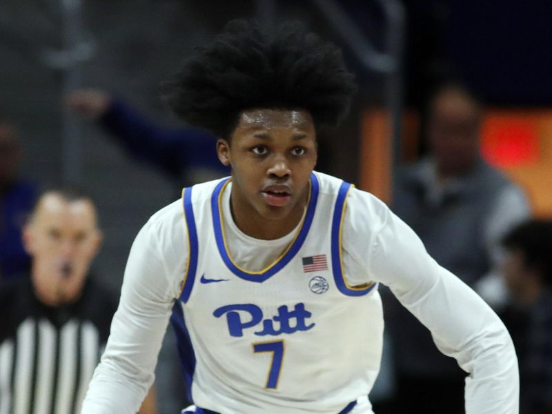 Dec 9, 2023; Pittsburgh, Pennsylvania, USA; Pittsburgh Panthers guard Carlton Carrington (7) brings the ball up court against the Canisius Golden Griffins during the first half at the Petersen Events Center. Mandatory Credit: Charles LeClaire-USA TODAY Sports