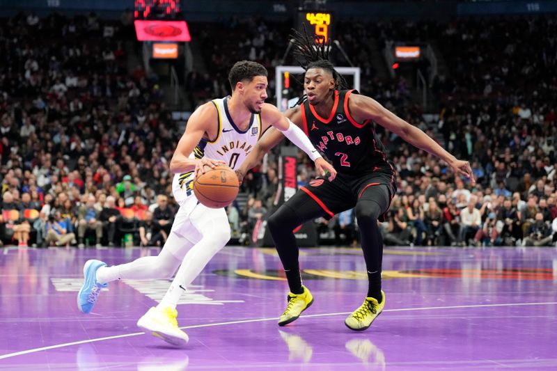 TORONTO, ON - DECEMBER 3: Tyrese Haliburton #0 of the Indiana Pacers dribbles against Jonathan Mogbo #2 of the Toronto Raptors during the Emirates NBA Cup game at the Scotiabank Arena on December 3, 2024 in Toronto, Ontario, Canada. NOTE TO USER: User expressly acknowledges and agrees that, by downloading and/or using this Photograph, user is consenting to the terms and conditions of the Getty Images License Agreement. (Photo by Kevin Sousa/Getty Images)