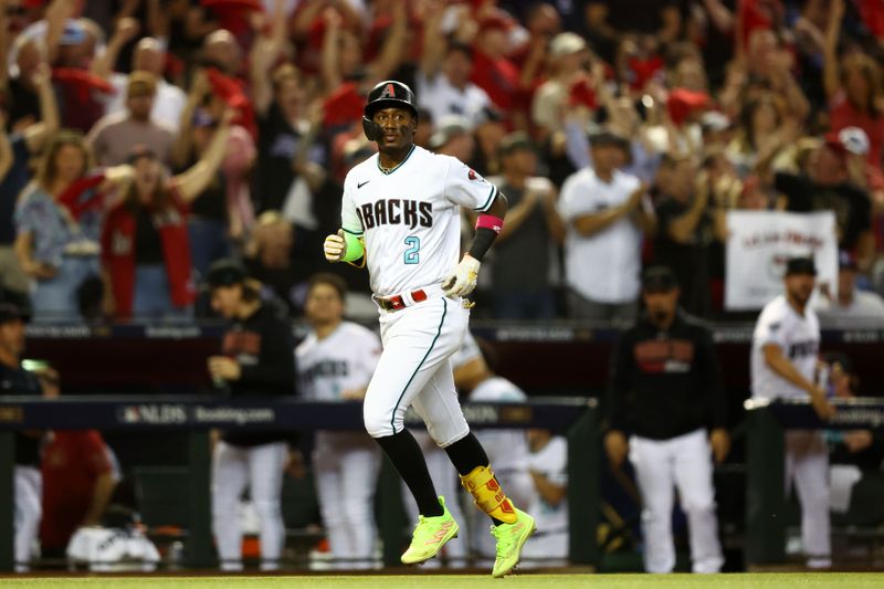 Oct 11, 2023; Phoenix, Arizona, USA; Arizona Diamondbacks shortstop Geraldo Perdomo (2) reacts after hitting a home run against the Los Angeles Dodgers in the third inning for game three of the NLDS for the 2023 MLB playoffs at Chase Field. Mandatory Credit: Mark J. Rebilas-USA TODAY Sports