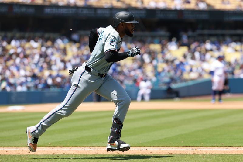 May 8, 2024; Los Angeles, California, USA;  Miami Marlins designated hitter Bryan De La Cruz (14) hits a single during the sixth inning against the Los Angeles Dodgers at Dodger Stadium. Mandatory Credit: Kiyoshi Mio-USA TODAY Sports