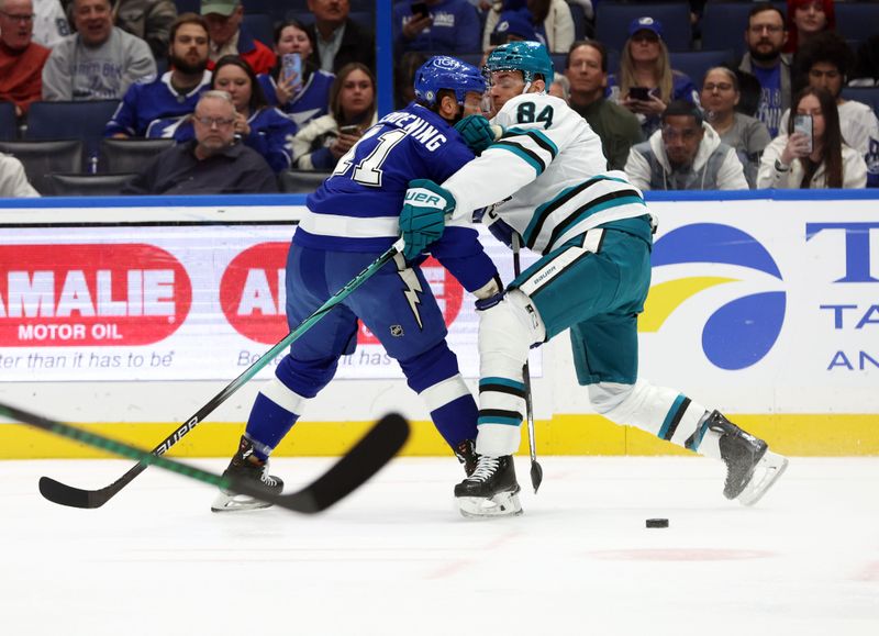 Dec 5, 2024; Tampa, Florida, USA; San Jose Sharks defenseman Jan Rutta (84) defends Tampa Bay Lightning center Luke Glendening (11) during the first period at Amalie Arena. Mandatory Credit: Kim Klement Neitzel-Imagn Images