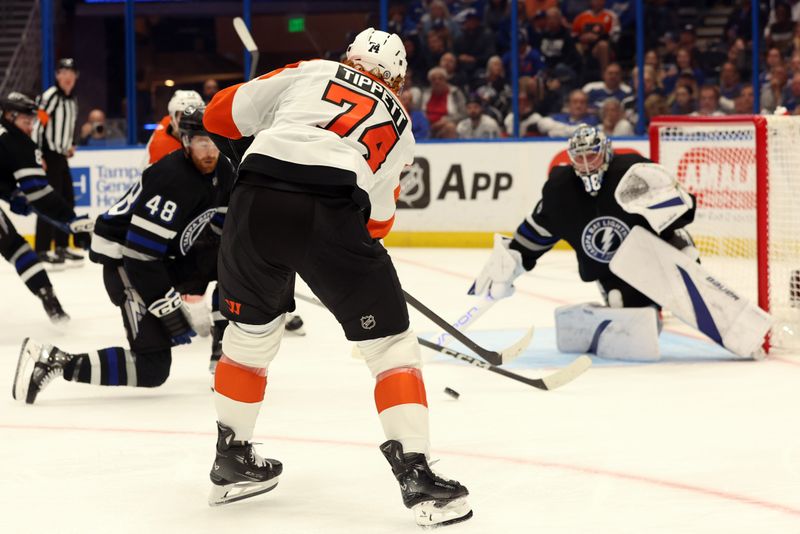 Mar 9, 2024; Tampa, Florida, USA; Philadelphia Flyers right wing Owen Tippett (74) shoots as Tampa Bay Lightning goaltender Andrei Vasilevskiy (88) defends during the second period at Amalie Arena. Mandatory Credit: Kim Klement Neitzel-USA TODAY Sports