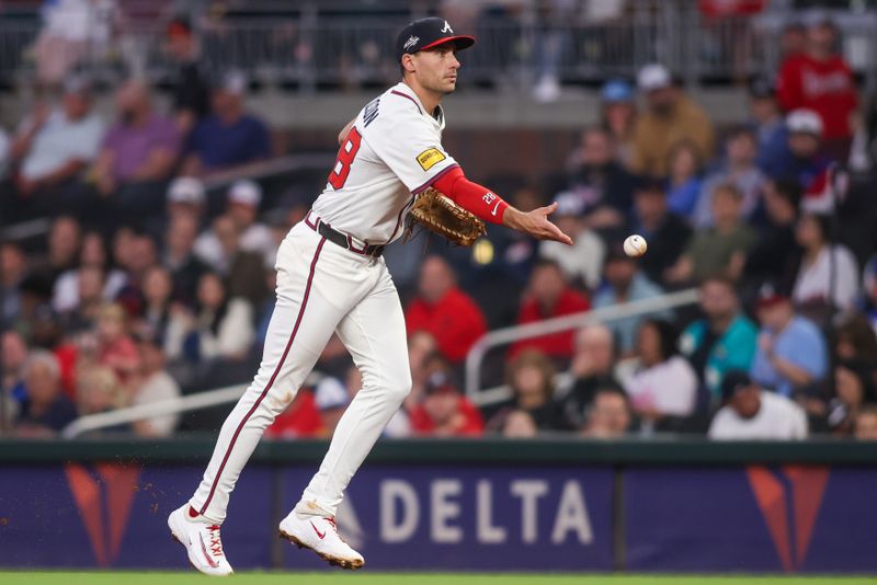 May 7, 2025; Atlanta, Georgia, USA; Atlanta Braves first baseman Matt Olson (28) tosses the ball to first base against the Cincinnati Reds in the fifth inning at Truist Park. Mandatory Credit: Brett Davis-Imagn Images
