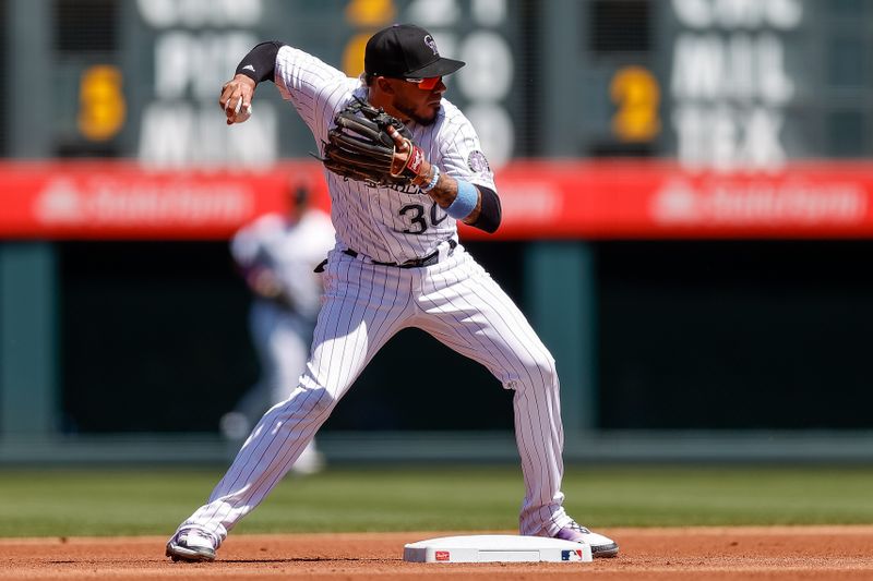 Aug 20, 2023; Denver, Colorado, USA; Colorado Rockies second baseman Harold Castro (30) turns a double play in the first inning against the Chicago White Sox at Coors Field. Mandatory Credit: Isaiah J. Downing-USA TODAY Sports