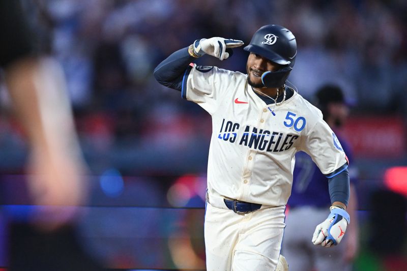 Sep 21, 2024; Los Angeles, California, USA; Los Angeles Dodgers outfielder Mookie Betts (50) hits a two-run home run against the Colorado Rockies during the third inning at Dodger Stadium. Mandatory Credit: Jonathan Hui-Imagn Images