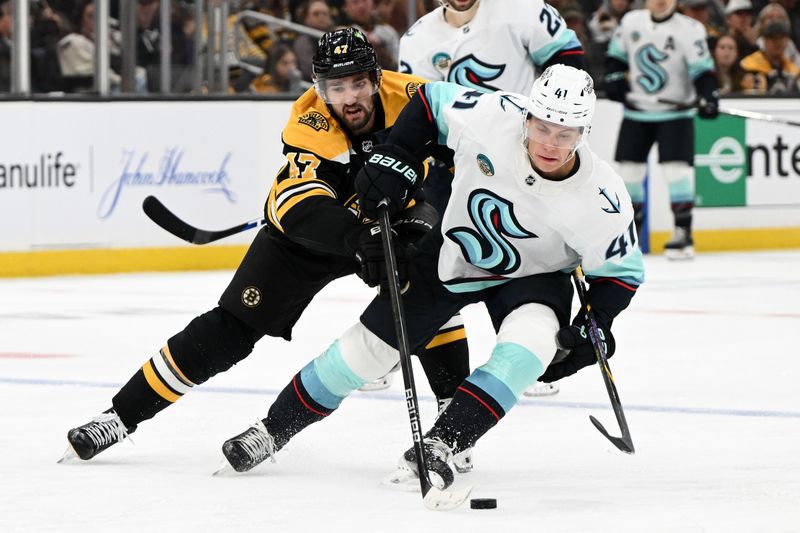 Nov 3, 2024; Boston, Massachusetts, USA; Seattle Kraken defenseman Ryker Evans (41) skates against Boston Bruins center Mark Kastelic (47) during the third period at the TD Garden. Mandatory Credit: Brian Fluharty-Imagn Images