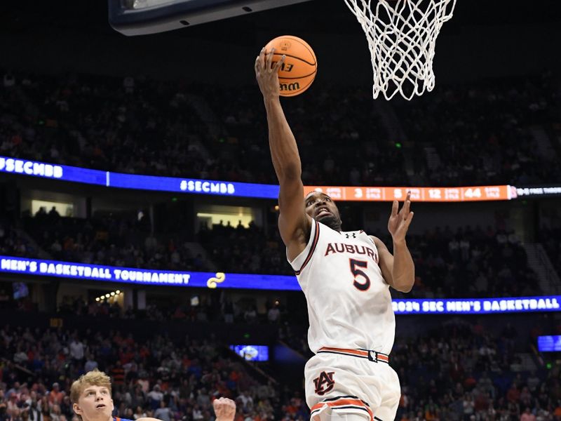 Mar 17, 2024; Nashville, TN, USA; Auburn Tigers forward Chris Moore (5) shoots against Florida Gators forward Thomas Haugh (10) in the second half in the SEC Tournament championship game at Bridgestone Arena. Mandatory Credit: Steve Roberts-USA TODAY Sports