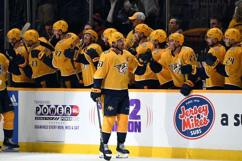 Nov 26, 2023; Nashville, Tennessee, USA; Nashville Predators defenseman Roman Josi (59) celebrates with teammates after a goal during the second period against the Winnipeg Jets at Bridgestone Arena. Mandatory Credit: Christopher Hanewinckel-USA TODAY Sports