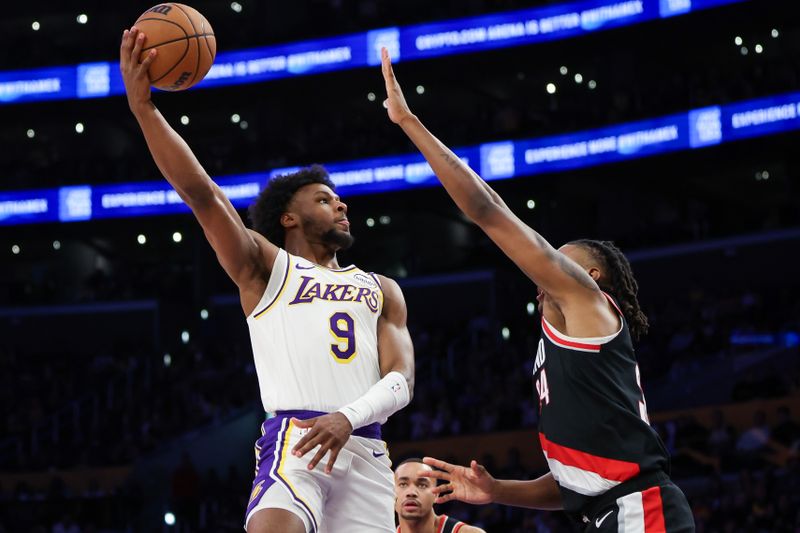 LOS ANGELES, CALIFORNIA - DECEMBER 08: Bronny James #9 of the Los Angeles Lakers shoots the ball defended by Jabari Walker #34 of the Portland Trail Blazers in the second half at Crypto.com Arena on December 08, 2024 in Los Angeles, California. NOTE TO USER: User expressly acknowledges and agrees that, by downloading and or using this Photograph, user is consenting to the terms and conditions of the Getty Images License Agreement. (Photo by Meg Oliphant/Getty Images)