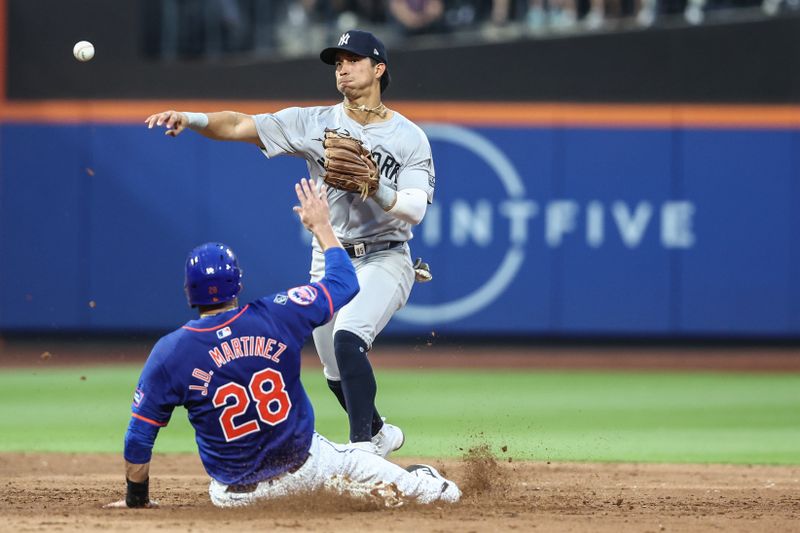 Jun 26, 2024; New York City, New York, USA;  New York Yankees second baseman Oswaldo Cabrera (95) throws past New York Mets designated hitter J.D. Martinez (28) attempting to complete a double play in the third inning at Citi Field. Mandatory Credit: Wendell Cruz-USA TODAY Sports