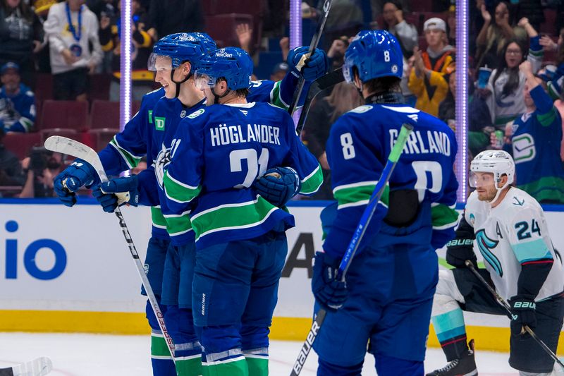 Sep 24, 2024; Vancouver, British Columbia, CAN;  Vancouver Canucks forward Aatu Raty (54) and forward Nils Hoglander (21) and forward Conor Garland (8) celebrate Hoglander’s goal against the Seattle Kraken during the first period at Rogers Arena. Mandatory Credit: Bob Frid-Imagn Images