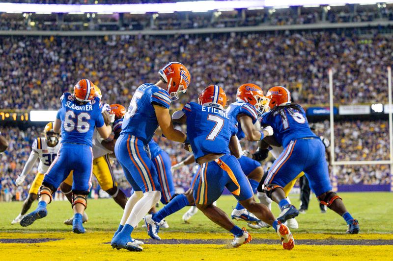 Nov 11, 2023; Baton Rouge, Louisiana, USA; Florida Gators quarterback Graham Mertz (15) hands off to running back Trevor Etienne (7) against the LSU Tigers  during the first half at Tiger Stadium. Mandatory Credit: Stephen Lew-USA TODAY Sports