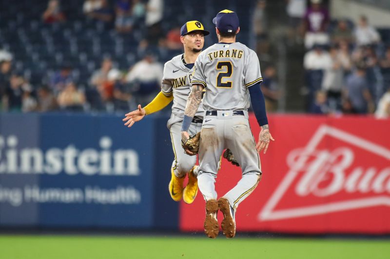 Sep 9, 2023; Bronx, New York, USA;  Milwaukee Brewers shortstop Willy Adames (27) and second baseman Brice Turang (2) celebrate after defeating the New York Yankees 9-2 at Yankee Stadium. Mandatory Credit: Wendell Cruz-USA TODAY Sports