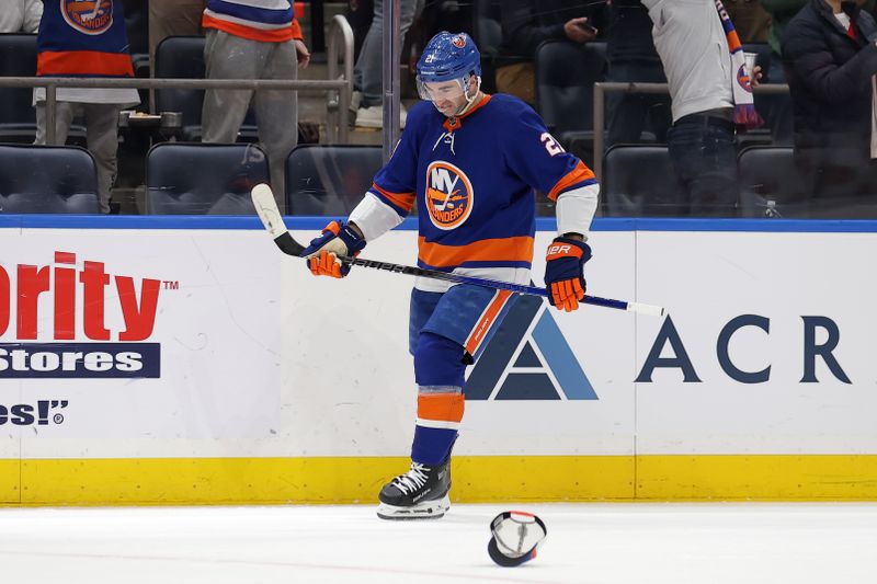 Mar 2, 2024; Elmont, New York, USA; New York Islanders center Kyle Palmieri (21) reacts as fans throw hats on the ice after his natural hat trick during the first period against the Boston Bruins at UBS Arena. Mandatory Credit: Brad Penner-USA TODAY Sports