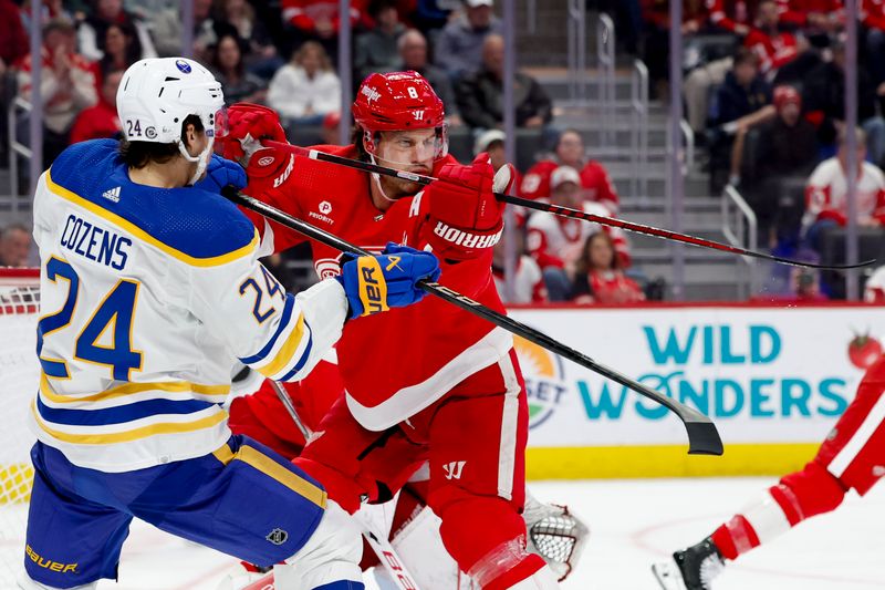 Mar 16, 2024; Detroit, Michigan, USA;  Buffalo Sabres center Dylan Cozens (24) and Detroit Red Wings defenseman Ben Chiarot (8) fight for position in the third period at Little Caesars Arena. Mandatory Credit: Rick Osentoski-USA TODAY Sports