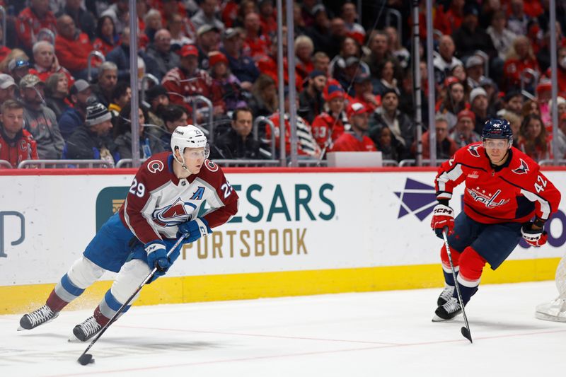 Feb 13, 2024; Washington, District of Columbia, USA; Colorado Avalanche center Nathan MacKinnon (29) skates with the puck as Washington Capitals defenseman Martin Fehervary (42) chases in the second period at Capital One Arena. Mandatory Credit: Geoff Burke-USA TODAY Sports