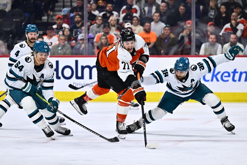 Mar 12, 2024; Philadelphia, Pennsylvania, USA; Philadelphia Flyers right wing Tyson Foerster (71) reaches to shoot the puck between San Jose Sharks defenseman Mario Ferraro (38) and center Mikael Granlund (64) in the first period at Wells Fargo Center. Mandatory Credit: Kyle Ross-USA TODAY Sports