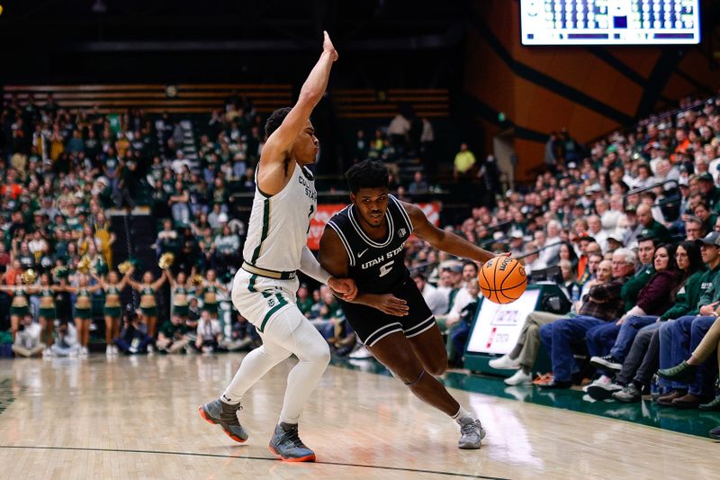 Feb 4, 2023; Fort Collins, Colorado, USA; Utah State Aggies guard RJ Eytle-Rock (5) controls the ball under pressure from Colorado State Rams guard John Tonje (1) in the first half at Moby Arena. Mandatory Credit: Isaiah J. Downing-USA TODAY Sports