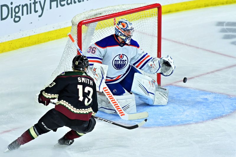 Mar 27, 2023; Tempe, Arizona, USA;  Edmonton Oilers goaltender Jack Campbell (36) drops the puck as Arizona Coyotes center Nathan Smith (13) attacks in the second period at Mullett Arena. Mandatory Credit: Matt Kartozian-USA TODAY Sports