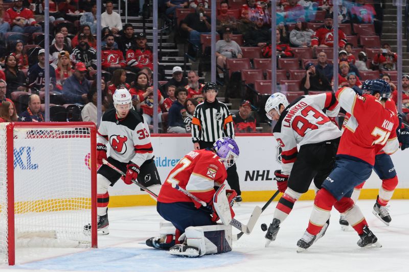 Nov 20, 2025; Sunrise, Florida, USA; Florida Panthers goaltender Sergei Bobrovsky (72) makes a save against New Jersey Devils center Juho Lammikko (83) during the first period at Amerant Bank Arena. Mandatory Credit: Sam Navarro-Imagn Images