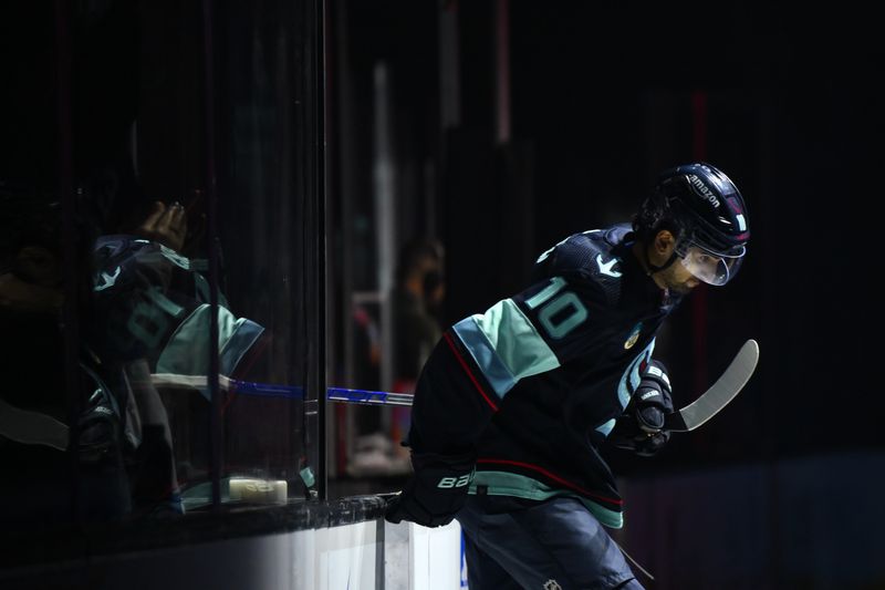 Dec 10, 2023; Seattle, Washington, USA; Seattle Kraken center Matty Beniers (10) enters the ice before the game against the Minnesota Wild at Climate Pledge Arena. Mandatory Credit: Steven Bisig-USA TODAY Sports