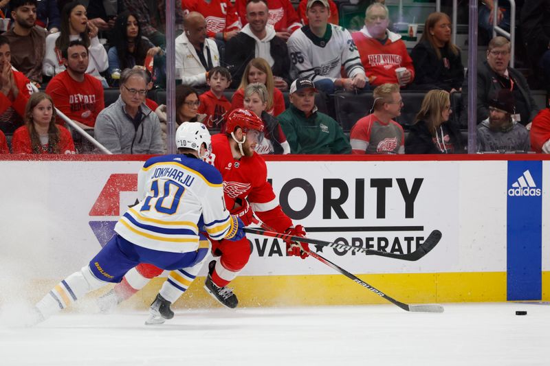 Apr 7, 2024; Detroit, Michigan, USA; Detroit Red Wings center Andrew Copp (18) skates with the puck chased by Buffalo Sabres defenseman Henri Jokiharju (10) in the second period at Little Caesars Arena. Mandatory Credit: Rick Osentoski-USA TODAY Sports