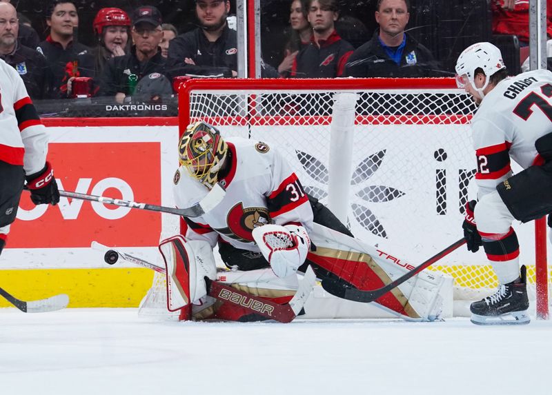 Nov 16, 2024; Raleigh, North Carolina, USA;  Ottawa Senators goaltender Anton Forsberg (31) stops the shot against the Carolina Hurricanes during the second period at Lenovo Center. Mandatory Credit: James Guillory-Imagn Images
