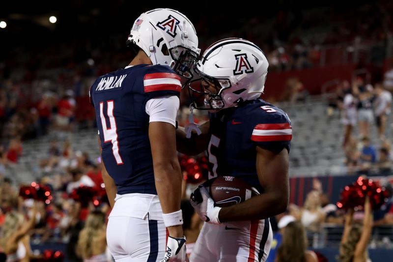 Sep 16, 2023; Tucson, Arizona, USA; Arizona Wildcats wide receiver Montana Lemonious-Craig (5) celebrates with wide receiver Tetairoa McMillan (4) after scoring a touchdown against the UTEP Miners during the second half at Arizona Stadium. Mandatory Credit: Zachary BonDurant-USA TODAY Sports