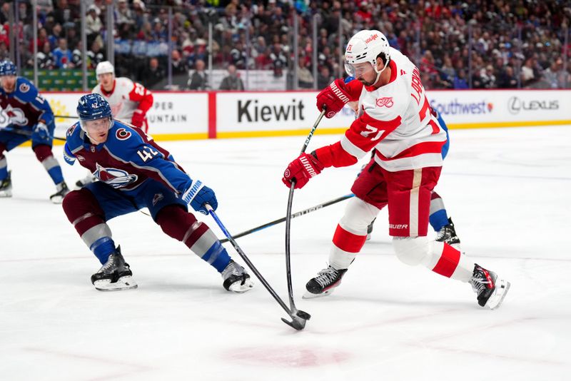 Feb 2, 2026; Denver, Colorado, USA; Colorado Avalanche defenseman Josh Manson (42) defends against Detroit Red Wings center Dylan Larkin (71) in the first period at Ball Arena. Mandatory Credit: Ron Chenoy-Imagn Images