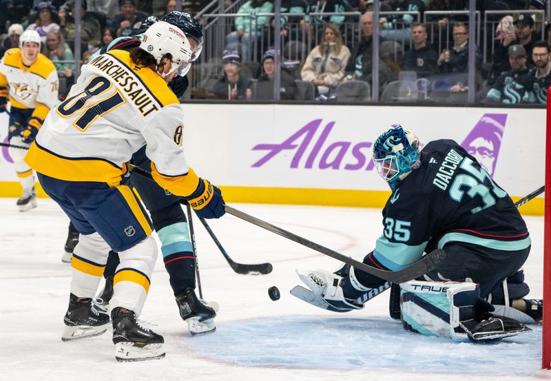 Nov 20, 2024; Seattle, Washington, USA;  Seattle Kraken goalie Joey Daccord (35) knocks away the puck from Nashville Predators forward Jonathan Marchessault (81) during the first period at Climate Pledge Arena. Mandatory Credit: Stephen Brashear-Imagn Images