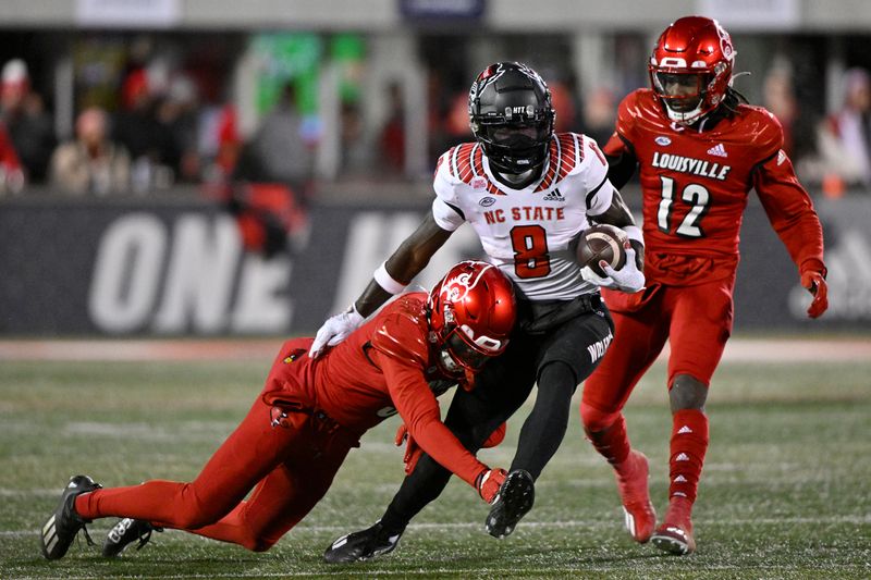 Nov 19, 2022; Louisville, Kentucky, USA;  North Carolina State Wolfpack wide receiver Julian Gray (8) runs the ball against Louisville Cardinals cornerback Quincy Riley (3) during the second half at Cardinal Stadium. Louisville won State 25-10. Mandatory Credit: Jamie Rhodes-USA TODAY Sports