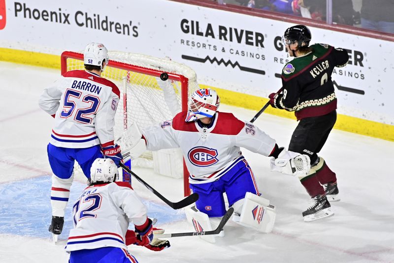 Nov 2, 2023; Tempe, Arizona, USA;  Montreal Canadiens goaltender Jake Allen (34), defenseman Justin Barron (52) and Arizona Coyotes right wing Clayton Keller (9) watch as a puck deflects off the cross bar in the first period at Mullett Arena. Mandatory Credit: Matt Kartozian-USA TODAY Sports.